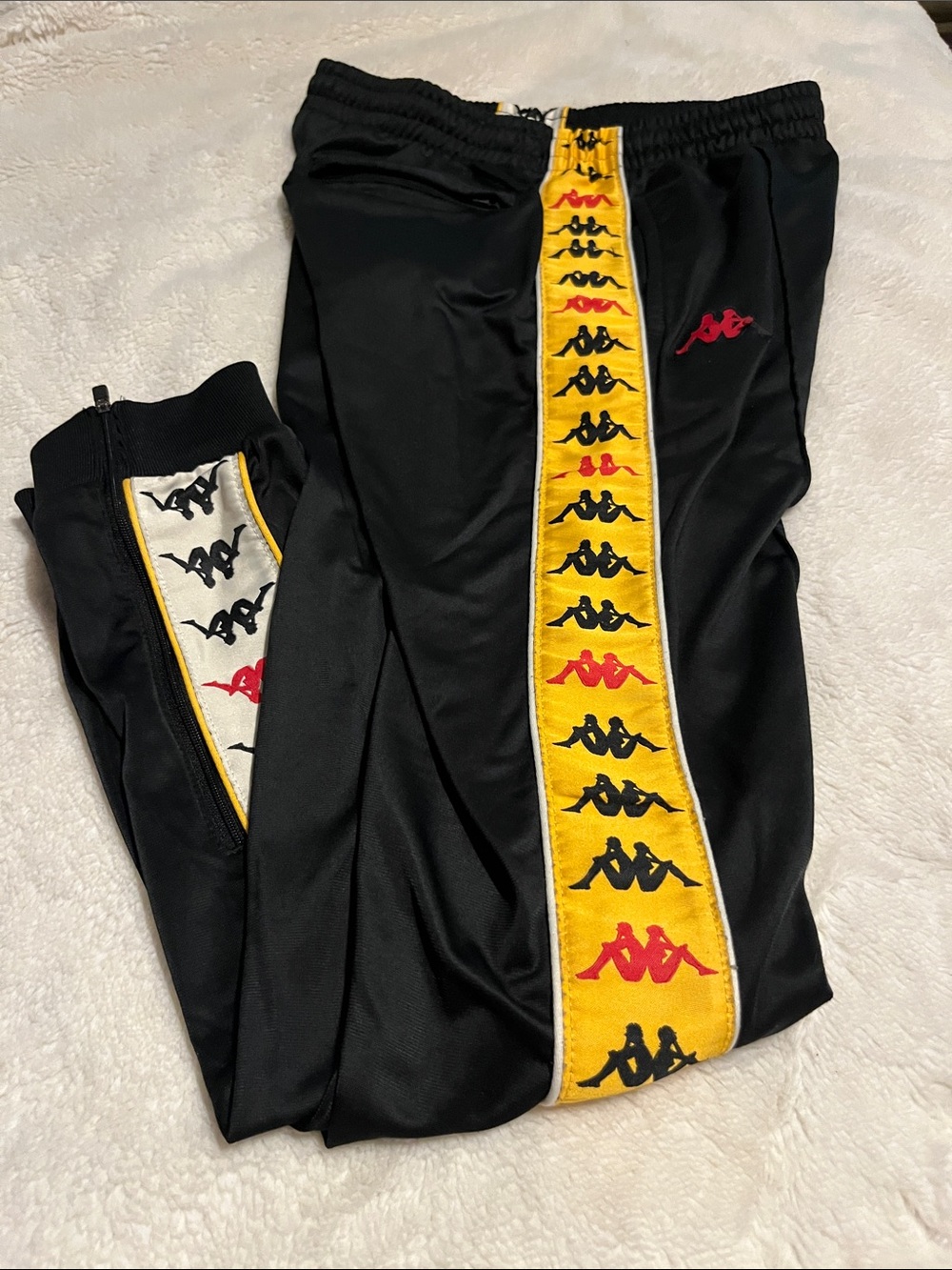 Kappa Black Track Pants with Yellow Logo Stripe and Red Accents